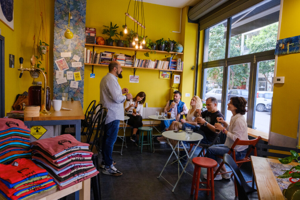 Panagiotis Karafoulidis introducing Greek coffee culture to a group inside a cozy Thessaloniki café