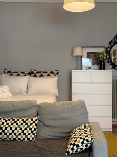 Modern one-bedroom apartment in the center of Thessaloniki with stylish living space, comfortable bed, and capacity for up to four guests.