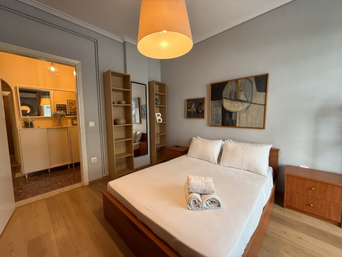 Modern one-bedroom apartment in the center of Thessaloniki with stylish living space, comfortable bed, and capacity for up to four guests.