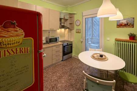 Modern one-bedroom apartment in the center of Thessaloniki with stylish living space, comfortable bed, and capacity for up to four guests.