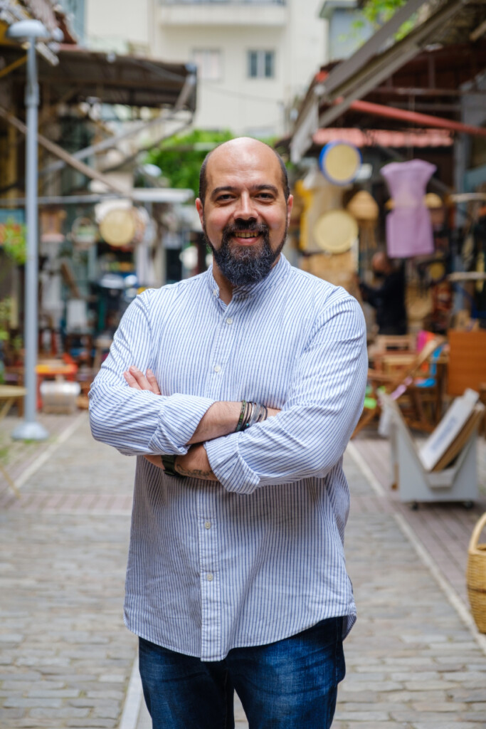 Panagiotis Karafoulidis standing in a traditional alley in Thessaloniki