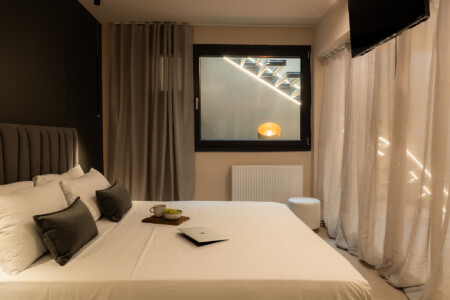 Dry Martini two-bedroom apartment in the city center with premium amenities, two bathrooms, stylish living room, and private balcony for a comfortable stay in Thessaloniki.