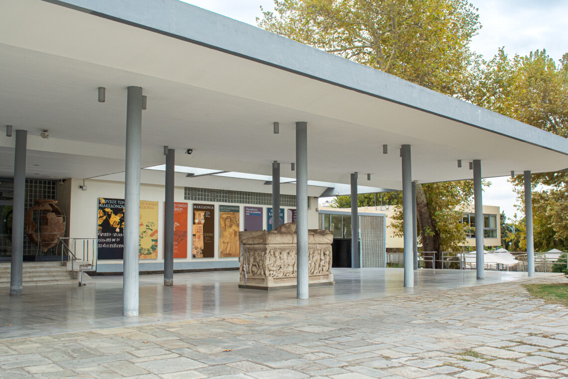 Entrance of the Archaeological Museum of Thessaloniki with modernist architecture and ancient sarcophagus on display