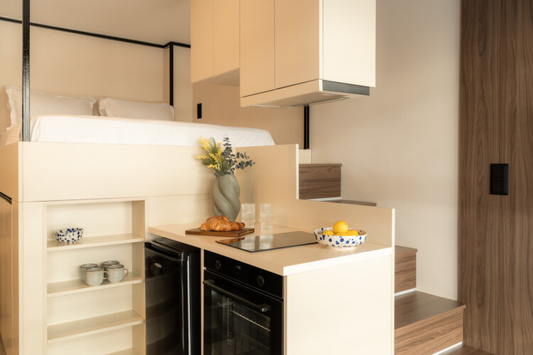 Compact and modern kitchen with coffee machine and wood finishes at FOS Apartments