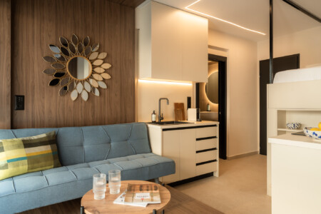 Bright living area with blue sofa and wall decor at FOS Apartments Loft