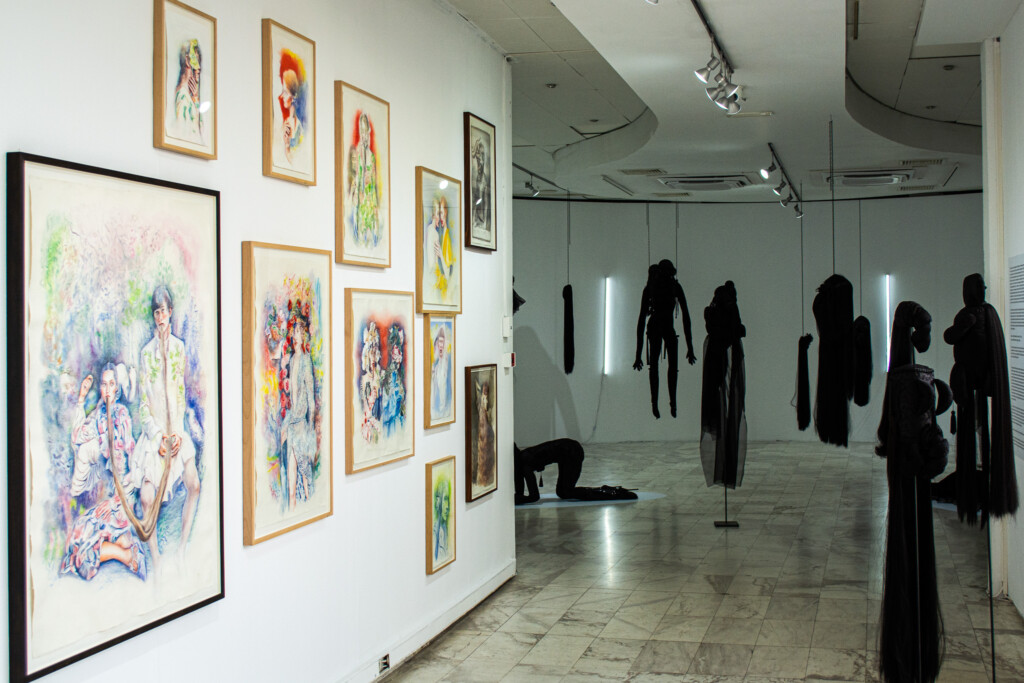 Colorful watercolor portraits and dark sculptural figures from Marianna Ignataki’s exhibition at MOMus Museum of Contemporary Art in Thessaloniki