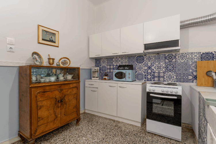 halu! Stylish kitchen with wooden cabinet tiled backsplash vintage decor white cabinets modern appliances and cozy atmosphere perfect for cooking and gathering