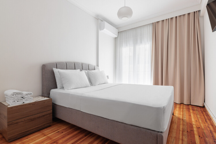 Cozy bedroom with a queen-size bed, fresh linens, and soft lighting. Features a large wardrobe, bedside tables, and a flat-screen TV, creating a comfortable and relaxing space for a restful stay.