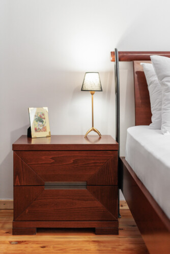 Cozy bedroom with a queen-size bed, fresh linens, and soft lighting. Features a large wardrobe, bedside tables, and a flat-screen TV, creating a comfortable and relaxing space for a restful stay.