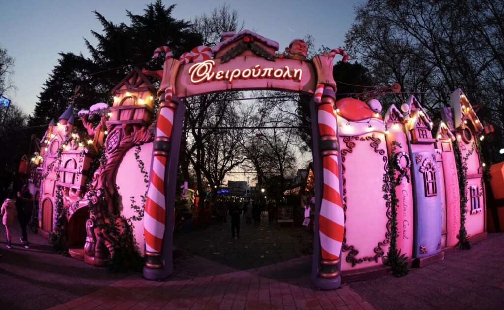 halu! Experience the enchanting Christmas village with colorful lights and festive decorations creating a magical holiday atmosphere in this captivating winter scene.