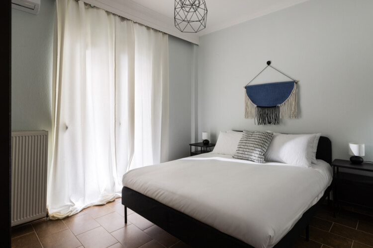 Halu! Experience cozy modern interior design in Indiana by halu! featuring a serene bedroom with natural light, a comfortable bed, and stylish minimalist decor.