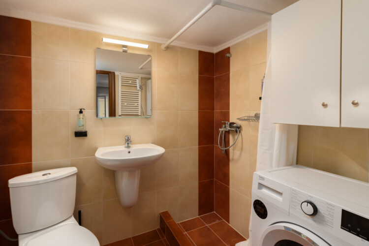 Halu! Modern bathroom interior designed by Indiana by halu featuring a white sink and toilet washing machine and minimalist decor ideal for contemporary home spaces