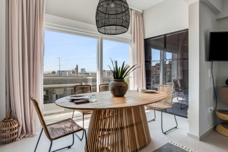 halu! Discover the elegant interior design of Verde premium apartments featuring a stylish dining area with large windows and natural light for a modern living experience