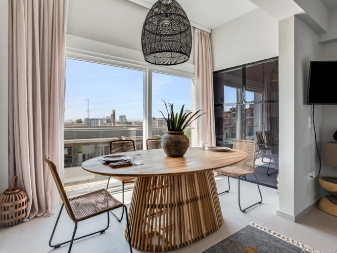 halu! Discover the elegant interior design of Verde premium apartments featuring a stylish dining area with large windows and natural light for a modern living experience