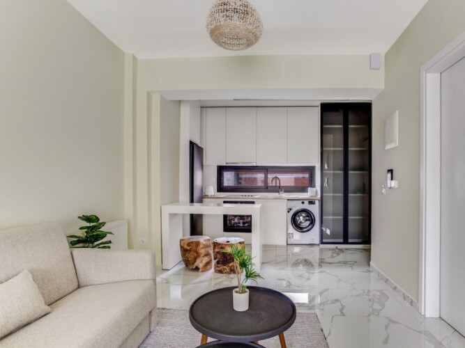 Halu! Discover modern elegance at Verde Premium Apartments offering stylish interiors with a cozy living space and sleek kitchen designed for comfortable urban living.