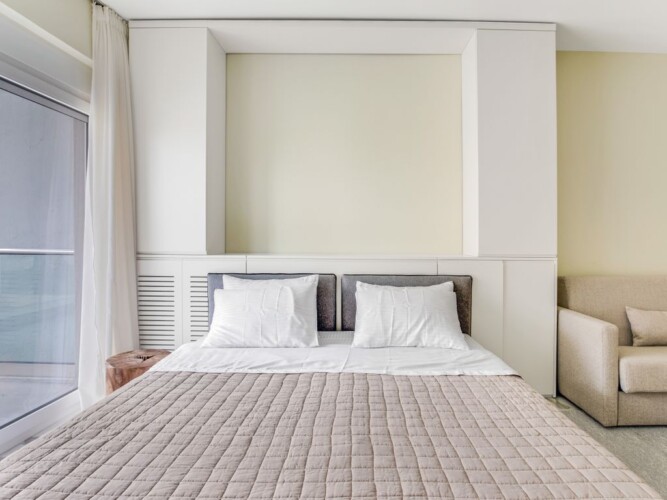 Halu! Discover ultimate comfort in Verde premium apartments featuring a cozy bedroom with modern design and natural light. Experience luxury living at its finest.