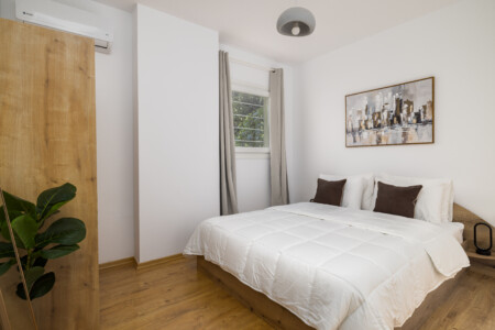 Halu! Experience comfort at Ourania Lofts and Suites in Thessaloniki featuring a cozy bedroom with a modern design ideal for a relaxing getaway.