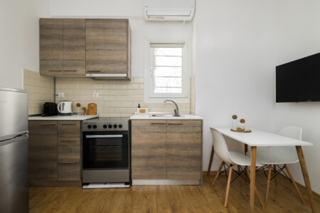 halu! Discover the modern kitchen in Ourania Lofts and Suites Thessaloniki featuring sleek cabinetry a dining area and contemporary amenities for a comfortable stay