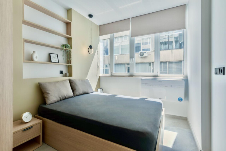 Halu! A modern suite at Odyssey - Premium SKG Suites in Ladadika Center offering a comfortable bed, contemporary decor, and ample natural light for a relaxing stay.