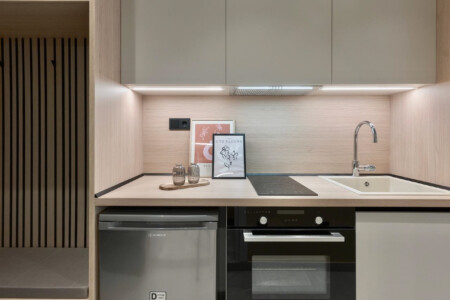 halu! Experience modern luxury at Odyssey - Premium SKG suites in the heart of Ladadika Center featuring sleek kitchen design with contemporary amenities.