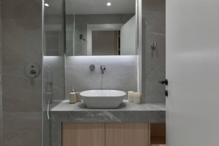 Halu! Discover luxury at Odyssey - Premium SKG suites in Ladadika Center. Elegant bathroom with modern design perfect for a relaxing stay in a central location.