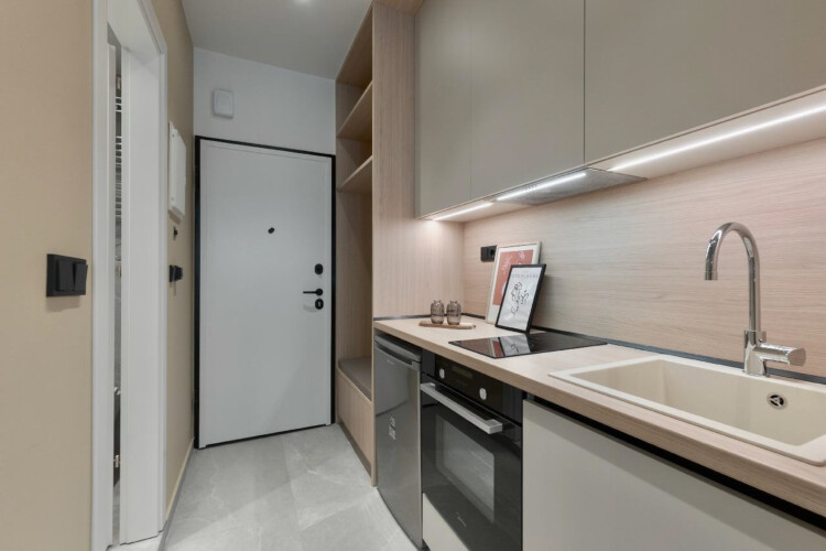 halu! Modern kitchenette view in Odyssey - Premium SKG suites located in Ladadika Center featuring sleek design and ample storage for a comfortable stay.