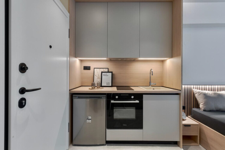 Halu! Discover the stylish kitchenette in Odyssey - Premium SKG suites located in the heart of Ladadika Center offering modern comforts and a sophisticated ambiance.