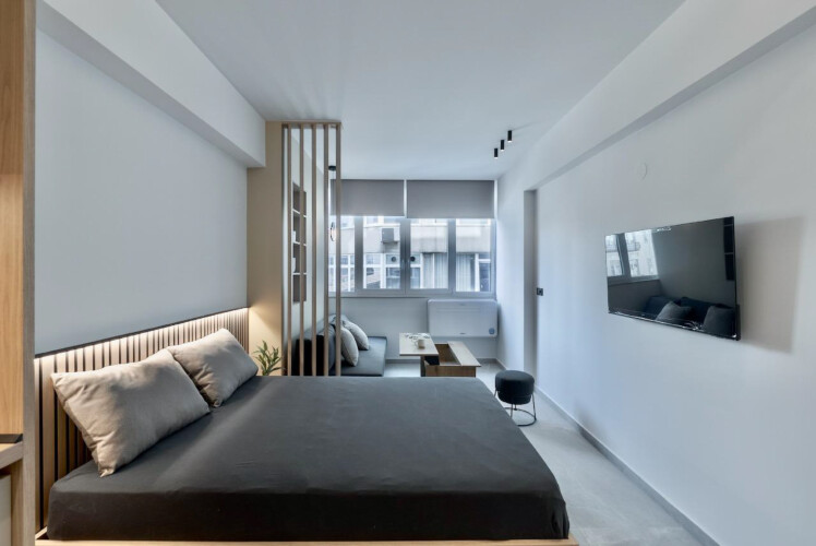 Halu! Discover the luxurious Odyssey - Premium SKG suites in Ladadika Center featuring a modern bedroom and living area perfect for an exceptional stay experience.